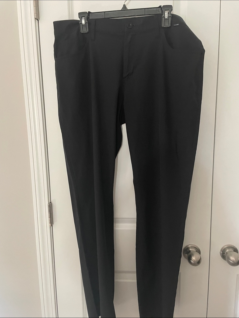 Travis Mathew’s black golf pants